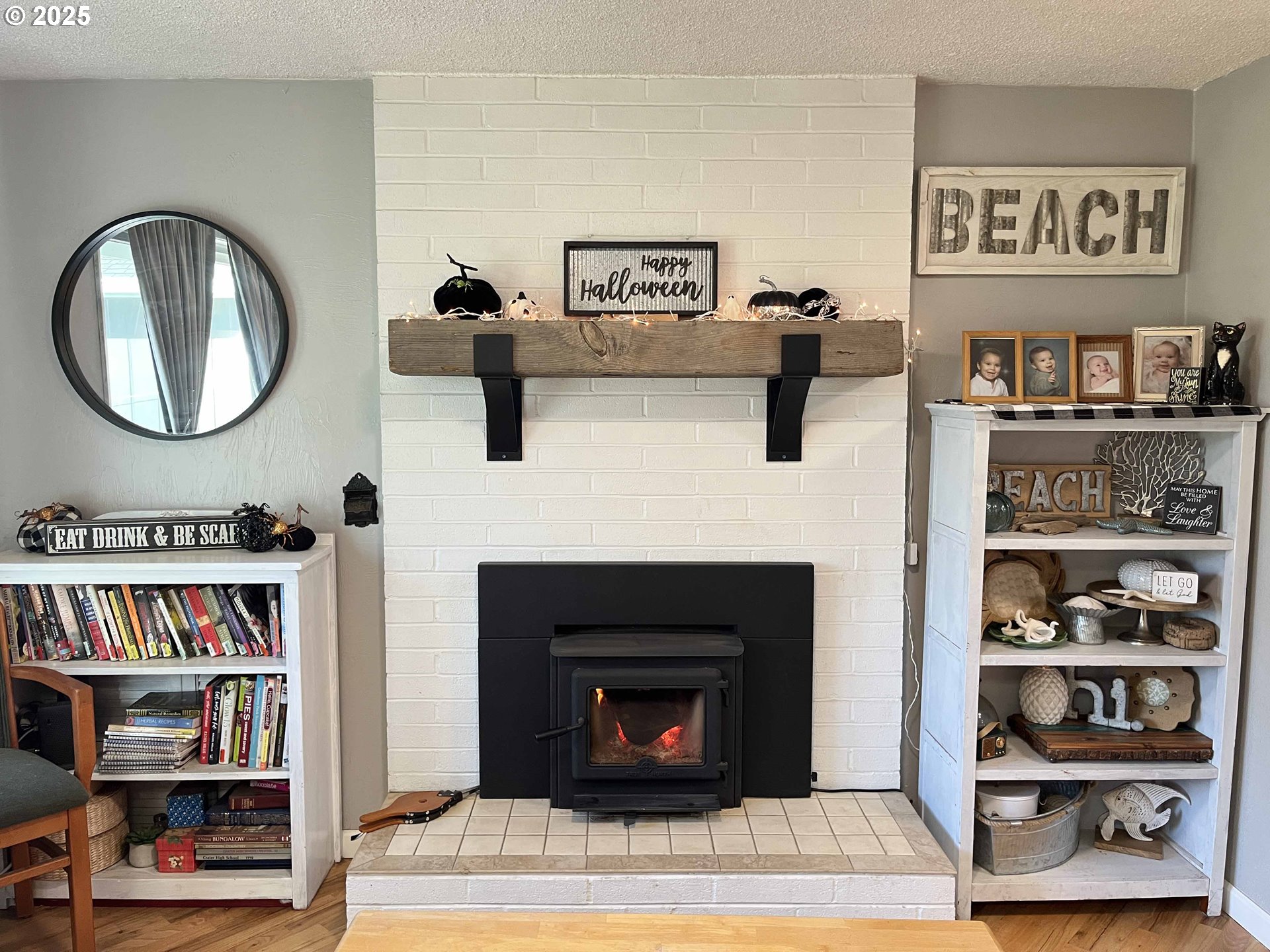 2045 19th Street Florence, OR 97439 - Photo 9 of 43 a living room with lots of books and a fireplace