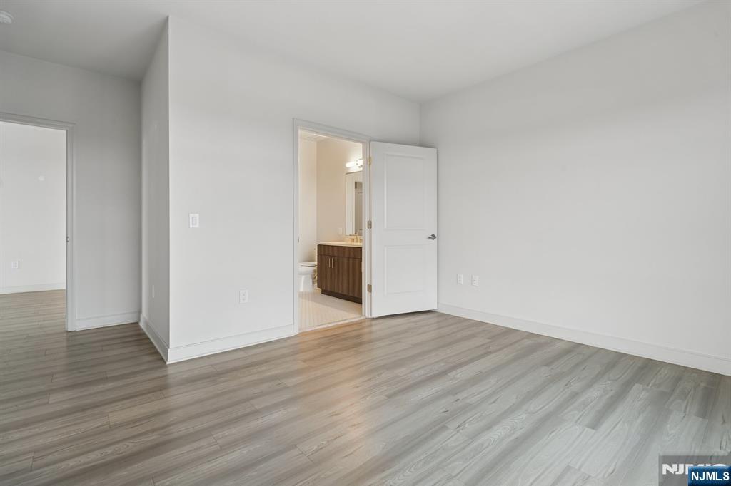 300 Market Street, Unit 422 Montvale, NJ 07645 - Photo 11 of 26 a view of an empty room with wooden floor