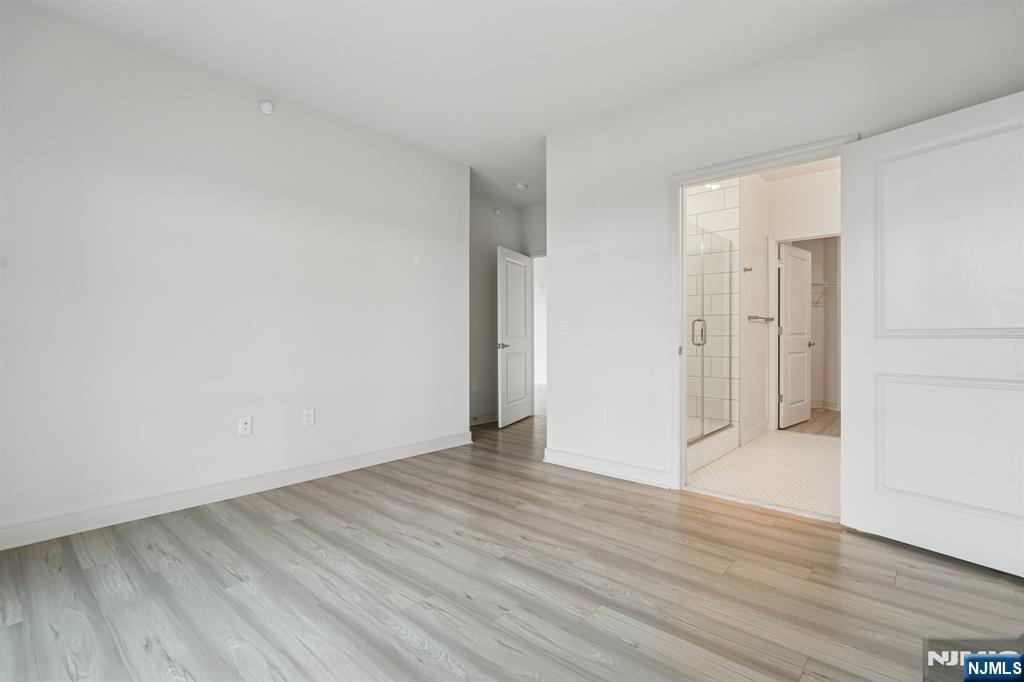 300 Market Street, Unit 422 Montvale, NJ 07645 - Photo 12 of 26 a view of an empty room with wooden floor and closet