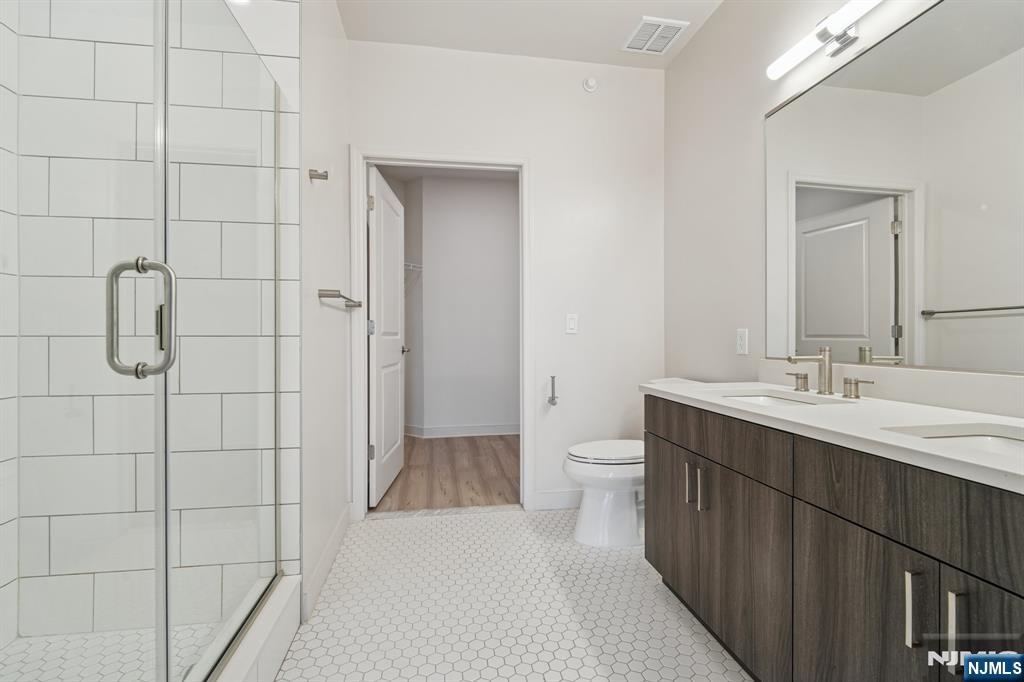 300 Market Street, Unit 422 Montvale, NJ 07645 - Photo 13 of 26 a bathroom with a sink toilet and shower