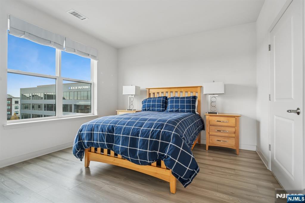 300 Market Street, Unit 422 Montvale, NJ 07645 - Photo 16 of 26 a bedroom with a bed and wooden floor