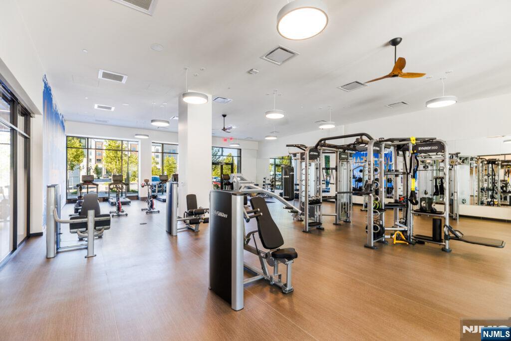 300 Market Street, Unit 422 Montvale, NJ 07645 - Photo 20 of 26 a living room with lots of furniture and gym equipment
