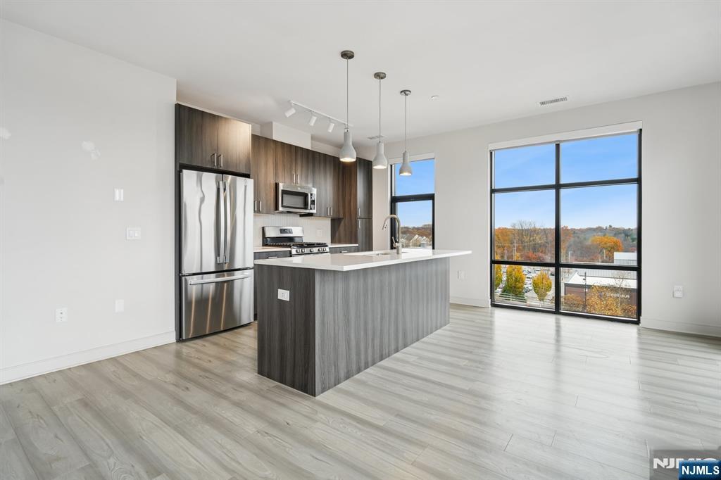 300 Market Street, Unit 422 Montvale, NJ 07645 - Photo 2 of 26 a kitchen with stainless steel appliances a refrigerator and wooden floor