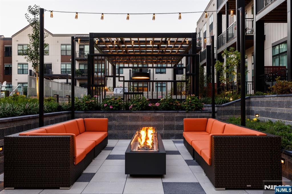 300 Market Street, Unit 422 Montvale, NJ 07645 - Photo 22 of 26 a outdoor space with patio couches and a fireplace