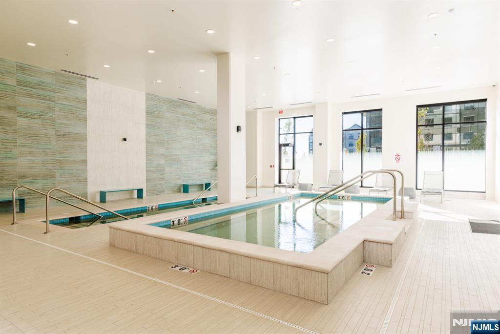 300 Market Street, Unit 422 Montvale, NJ 07645 - Photo 23 of 26 a living room with furniture and a table