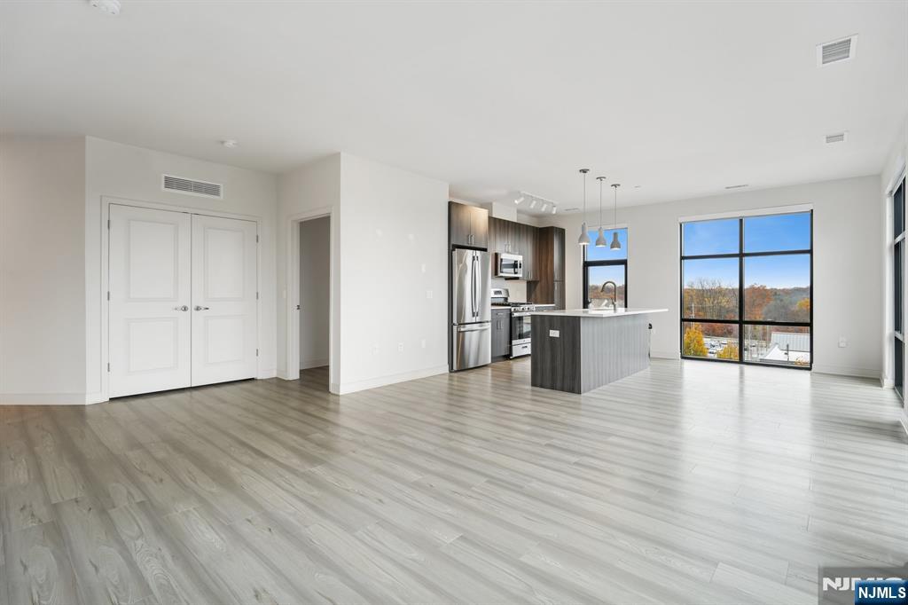 300 Market Street, Unit 422 Montvale, NJ 07645 - Photo 3 of 26 a view of a kitchen with wooden floor and a cabinet