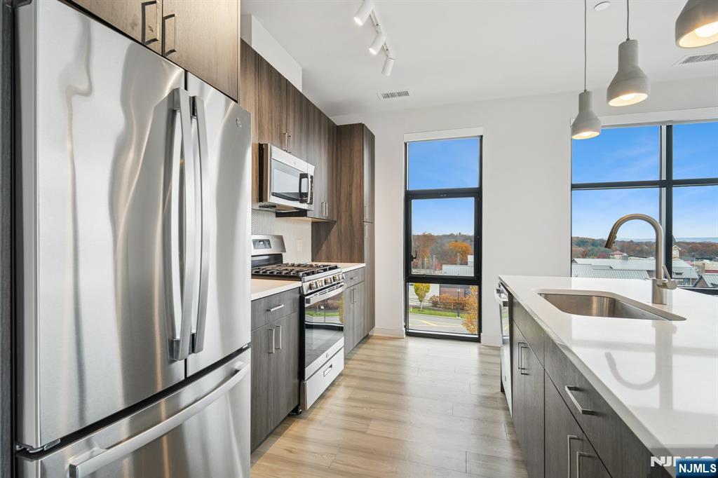 300 Market Street, Unit 422 Montvale, NJ 07645 - Photo 7 of 26 a kitchen with stainless steel appliances granite countertop a refrigerator and a sink