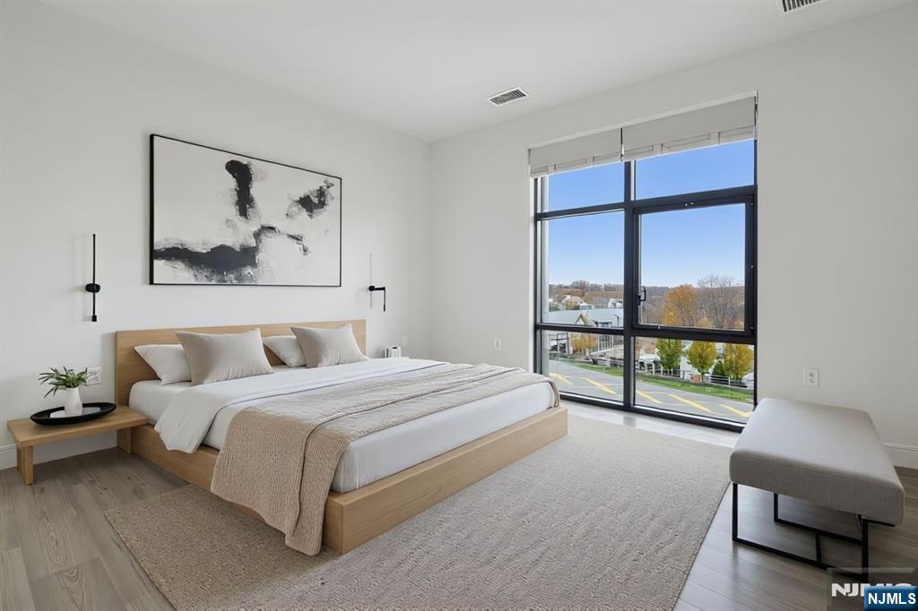 300 Market Street, Unit 422 Montvale, NJ 07645 - Photo 10 of 26 a spacious bedroom with a bed and a large window