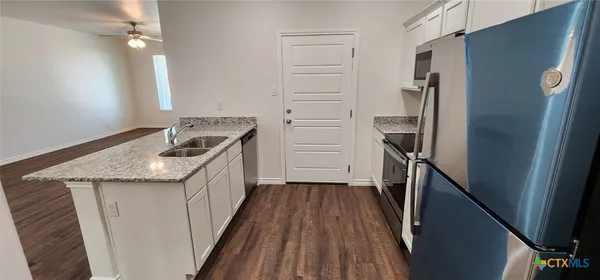 a kitchen with a refrigerator a sink and dishwasher