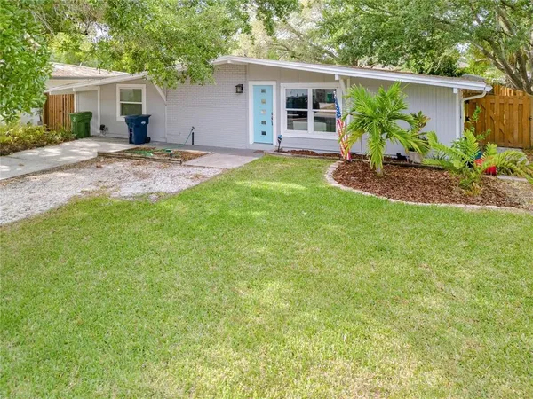 a view of a house with a patio and yard