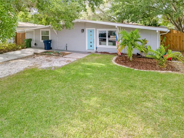 a view of a house with a patio and yard