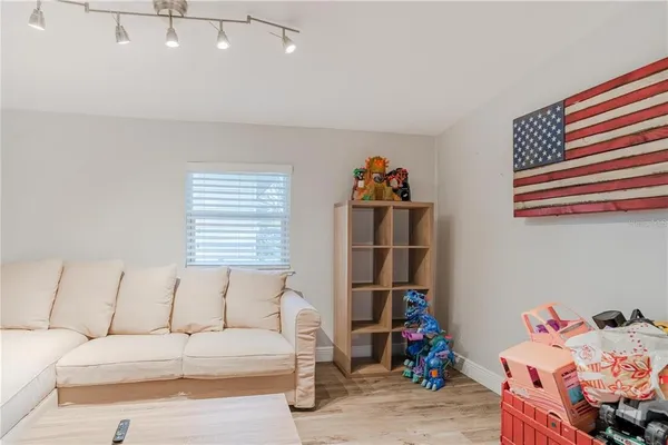 a living room with furniture and a book shelf