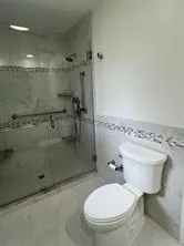 a bathroom with a toilet and a shower