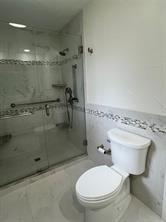 7 Yale Circle Richardson, TX 75081 - Photo 18 of 19 a bathroom with a toilet and a shower