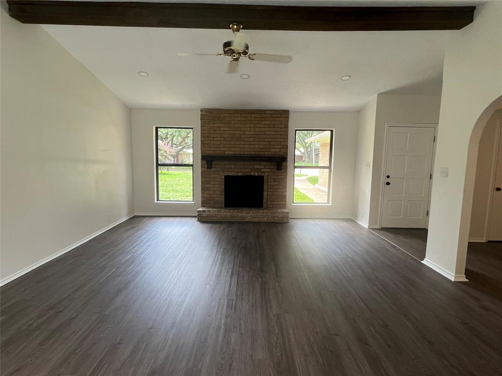 7 Yale Circle Richardson, TX 75081 - Photo 3 of 19 an empty room with wooden floor fireplace and windows