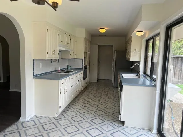 a kitchen with stainless steel appliances granite countertop a stove a sink and a refrigerator