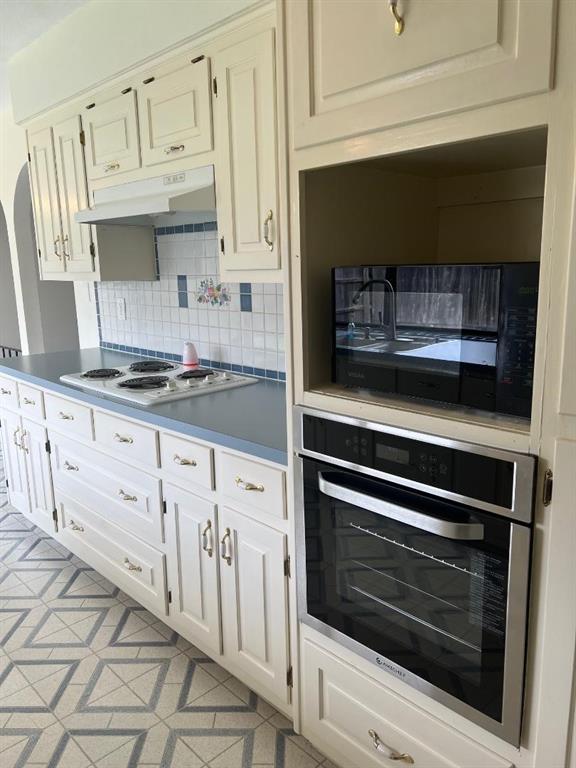 7 Yale Circle Richardson, TX 75081 - Photo 7 of 19 a kitchen with granite countertop white cabinets and appliances