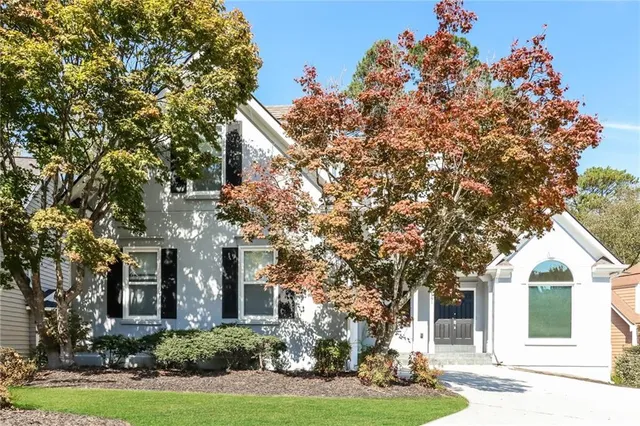 front view of a house with a tree