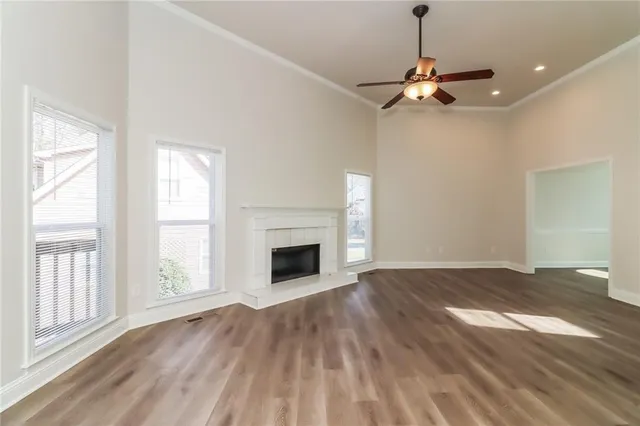 an empty room with wooden floor and fireplace