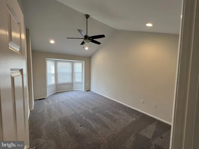 a bed sitting in a room next to a window