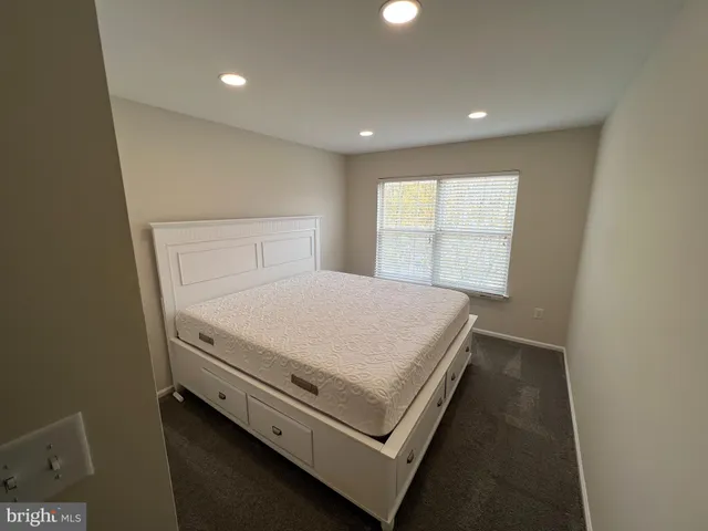 a bed sitting in a room next to a window