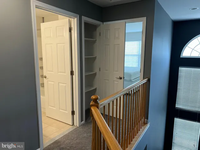 a bathroom with a double vanity sink and mirror with toilet