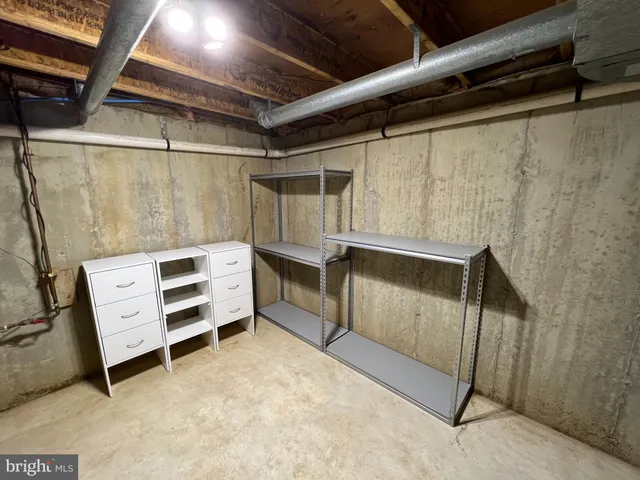 a view of a room with wooden floor and a hallway