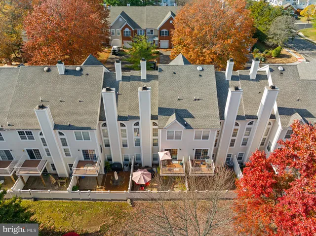 a view of a balcony with two chairs and a barbeque