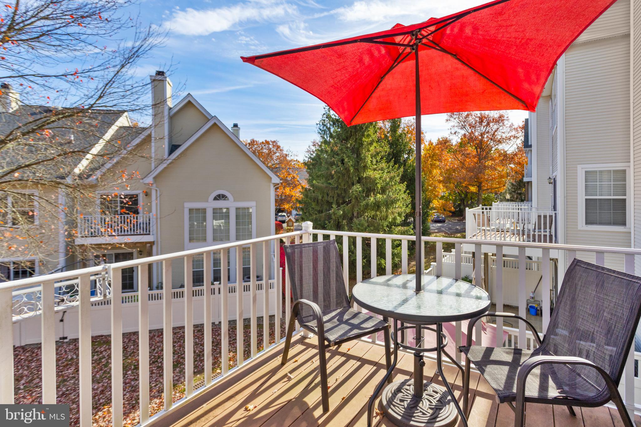 10 Howe Court Pennington, NJ 08534 - Photo 31 of 39 a view of a patio with a table and chairs under an umbrella