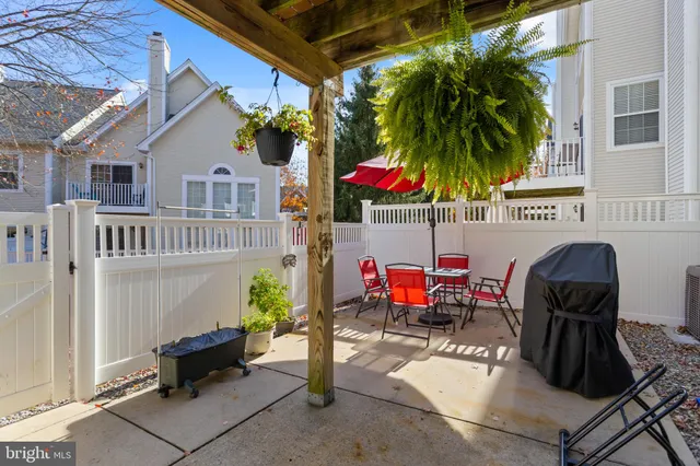 a view of a patio with a dining table and chairs under an umbrella