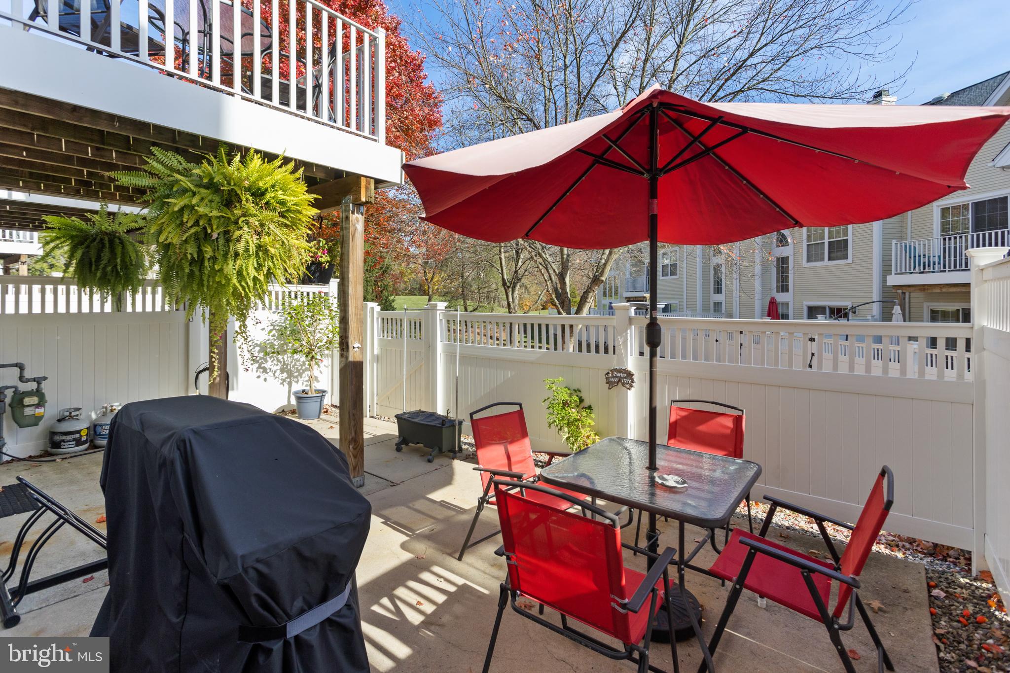 10 Howe Court Pennington, NJ 08534 - Photo 35 of 39 a patio with a table and chairs under an umbrella