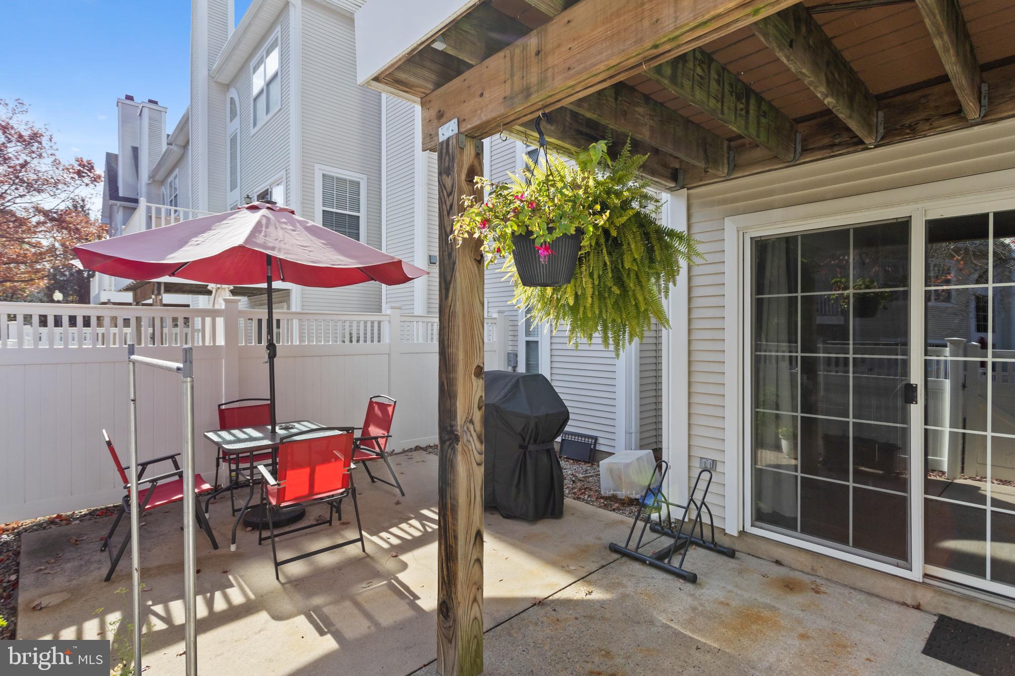 10 Howe Court Pennington, NJ 08534 - Photo 36 of 39 a patio with a patio table and chairs