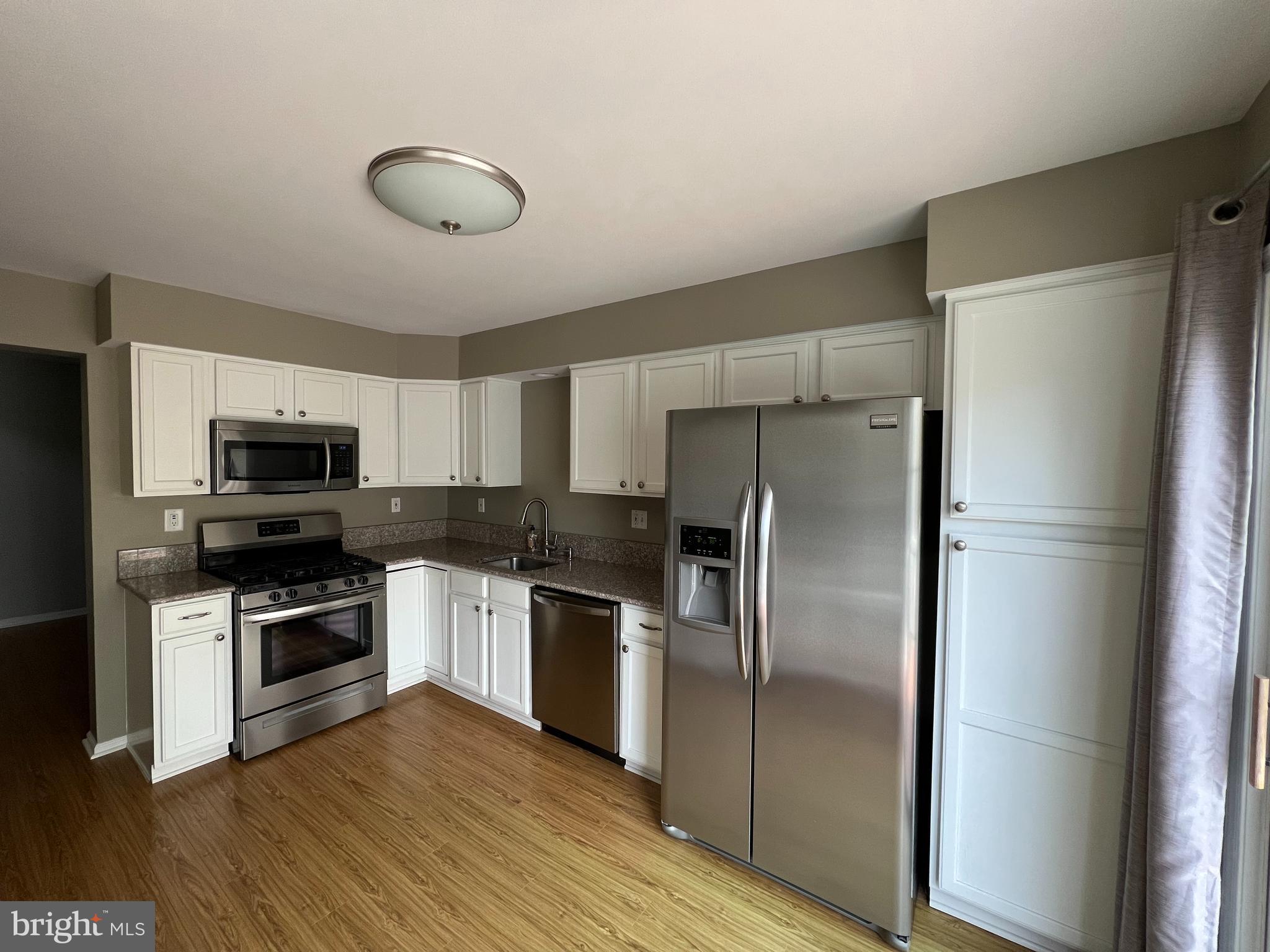 10 Howe Court Pennington, NJ 08534 - Photo 8 of 39 a kitchen with a refrigerator sink and stainless steel appliances