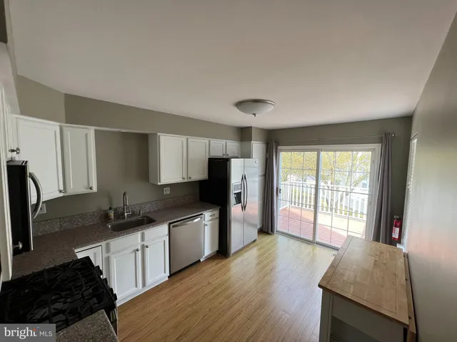 a view of an empty room with fireplace stairs