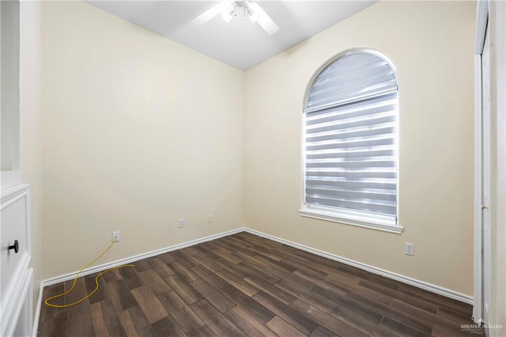 105 East Hawk Avenue McAllen, TX 78504 - Photo 17 of 34 an empty room with wooden floor and windows