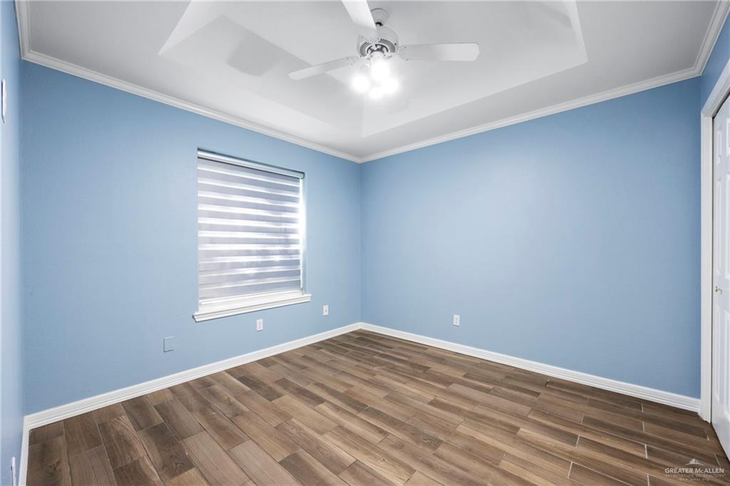 105 East Hawk Avenue McAllen, TX 78504 - Photo 19 of 34 wooden floor in an empty room with a window