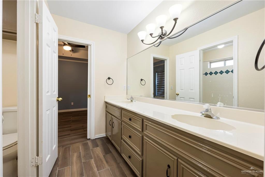 105 East Hawk Avenue McAllen, TX 78504 - Photo 20 of 34 a spacious bathroom with a double vanity sink and a mirror