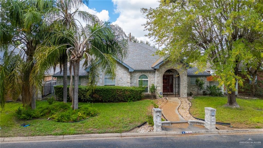 105 East Hawk Avenue McAllen, TX 78504 - Photo 25 of 34 a front view of a house with garden and trees