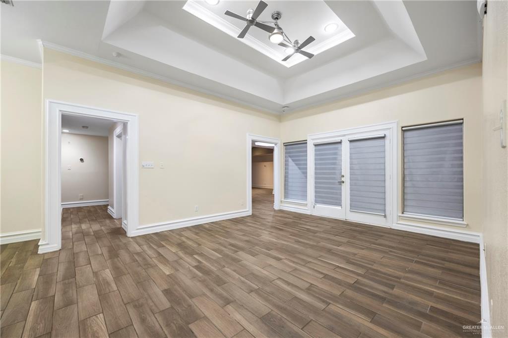 105 East Hawk Avenue McAllen, TX 78504 - Photo 3 of 34 a view of an empty room with wooden floor and a window