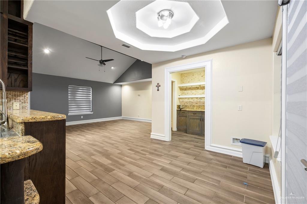 105 East Hawk Avenue McAllen, TX 78504 - Photo 8 of 34 a view of an empty room with wooden floor and a window