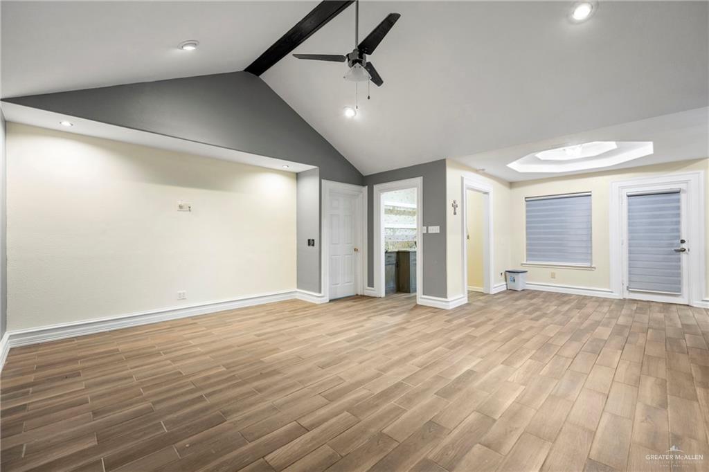 105 East Hawk Avenue McAllen, TX 78504 - Photo 10 of 34 a view of an empty room with window and wooden floor