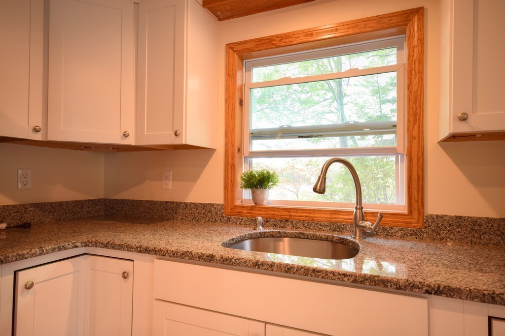89 Lakeview Avenue Bellingham, MA 02019 - Photo 13 of 30 a kitchen with granite countertop white cabinets and a sink