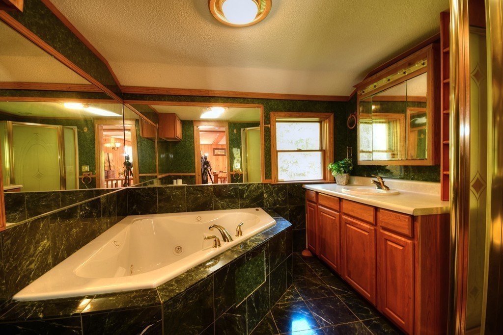 89 Lakeview Avenue Bellingham, MA 02019 - Photo 16 of 30 a bathroom with a granite countertop sink and a large mirror