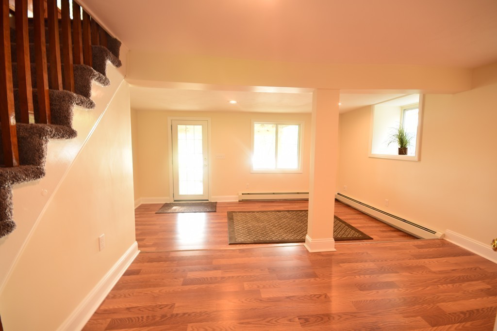 89 Lakeview Avenue Bellingham, MA 02019 - Photo 18 of 30 a view of empty room with wooden floor and fan