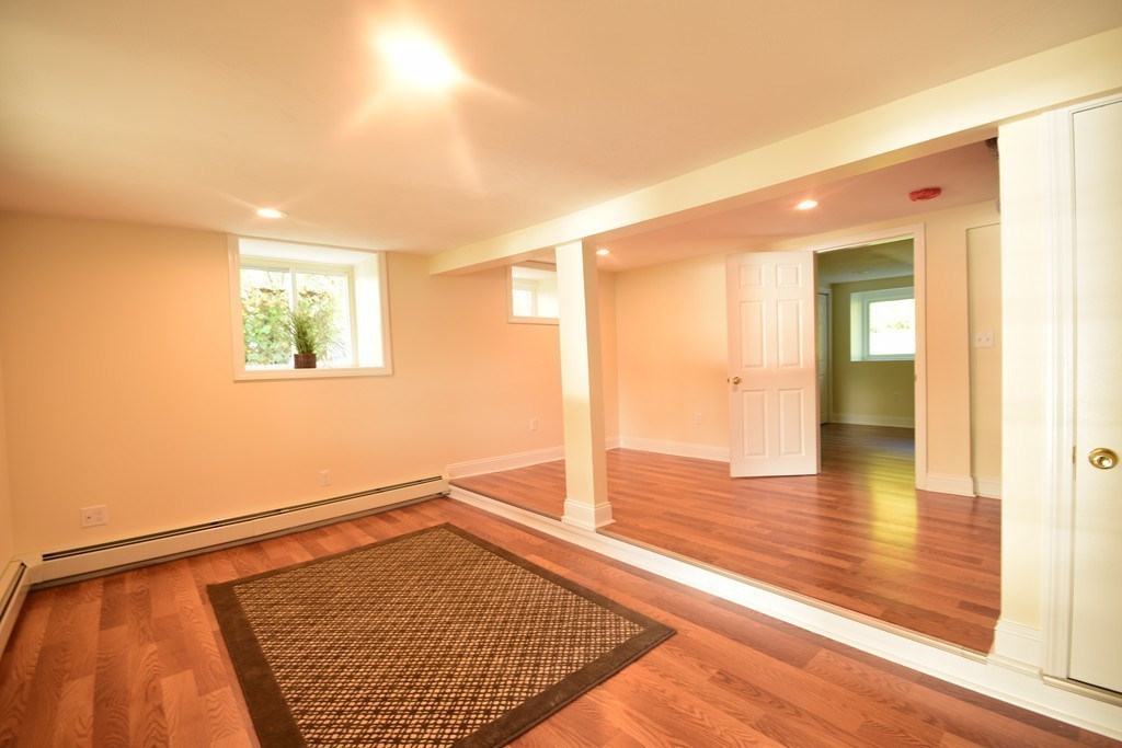 89 Lakeview Avenue Bellingham, MA 02019 - Photo 19 of 30 a view of an empty room with wooden floor and a window