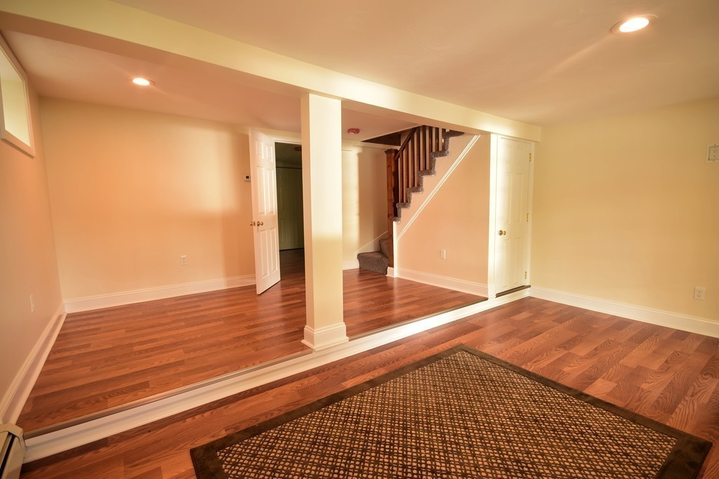 89 Lakeview Avenue Bellingham, MA 02019 - Photo 20 of 30 a view of a room with wooden floor and staircase