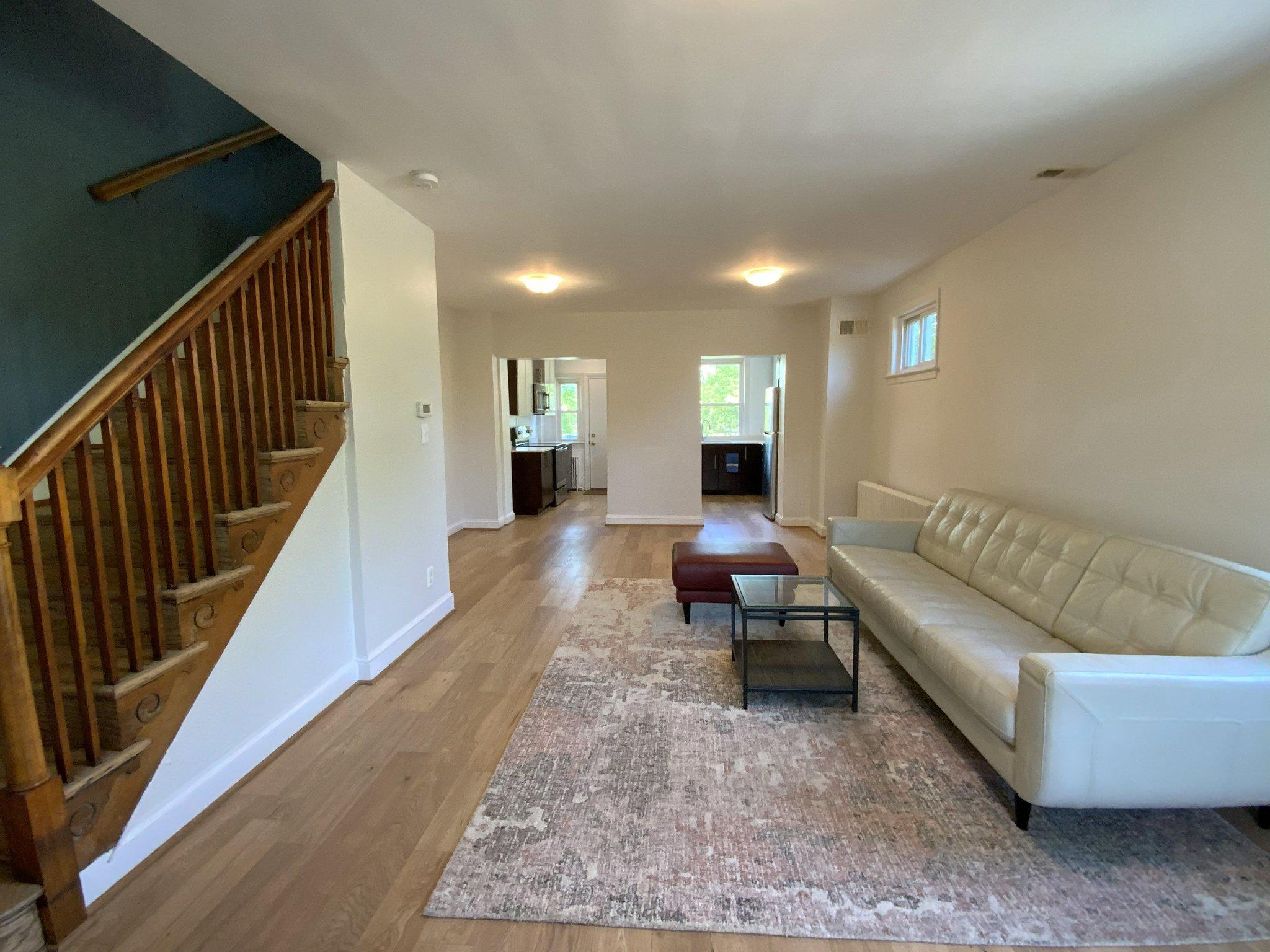 1772 E Street Northeast Washington, DC 20002 - Photo 23 of 23 a living room with furniture and a rug