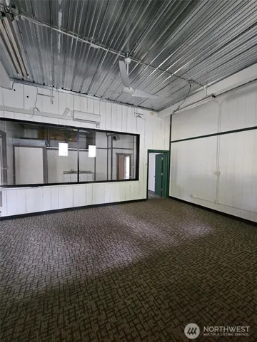 a view of an empty room with kitchen natural light