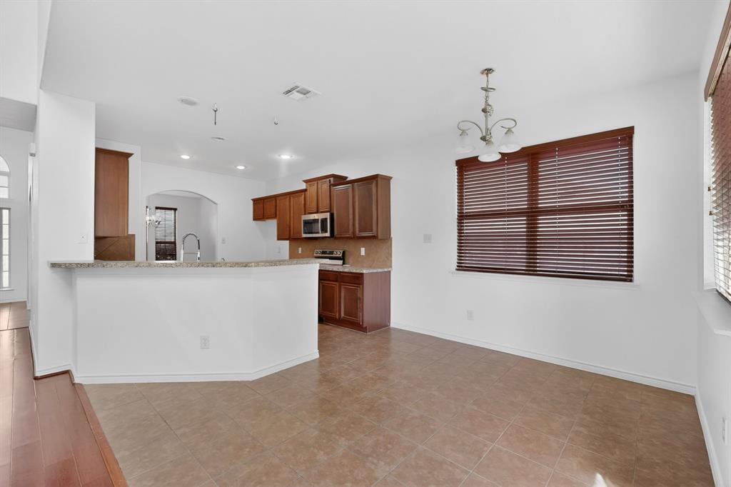 426 Harding Lane Lavon, TX 75166 - Photo 15 of 40 Dining area with tile flooring and a multi-light chandelier