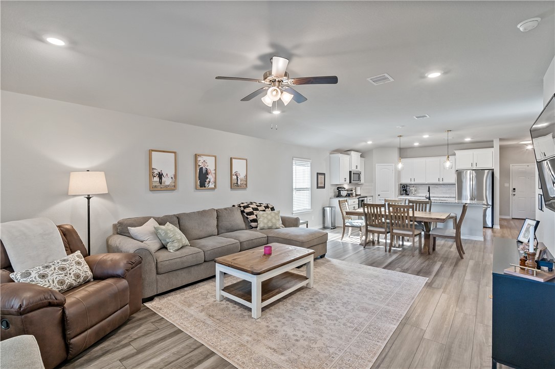 2135 Chief Street Bryan, TX 77807 - Photo 12 of 26 a living room with furniture kitchen view and a chandelier
